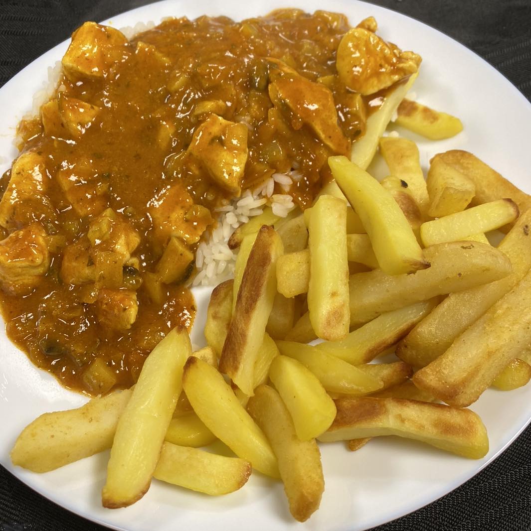 Picture of chicken curry with rice and chips