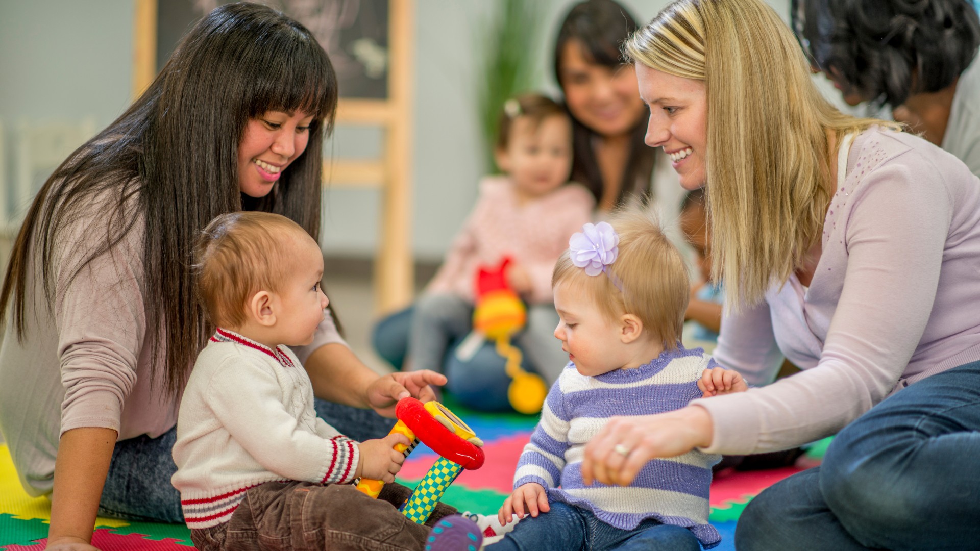 image of toddlers and adults playing