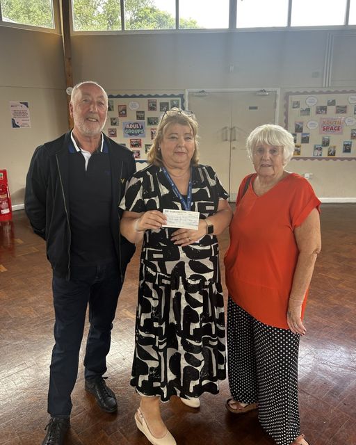 C.E.O Trish Cornish being awarded a check by representatives of The Royal Navy Club - Colin and Pauline.