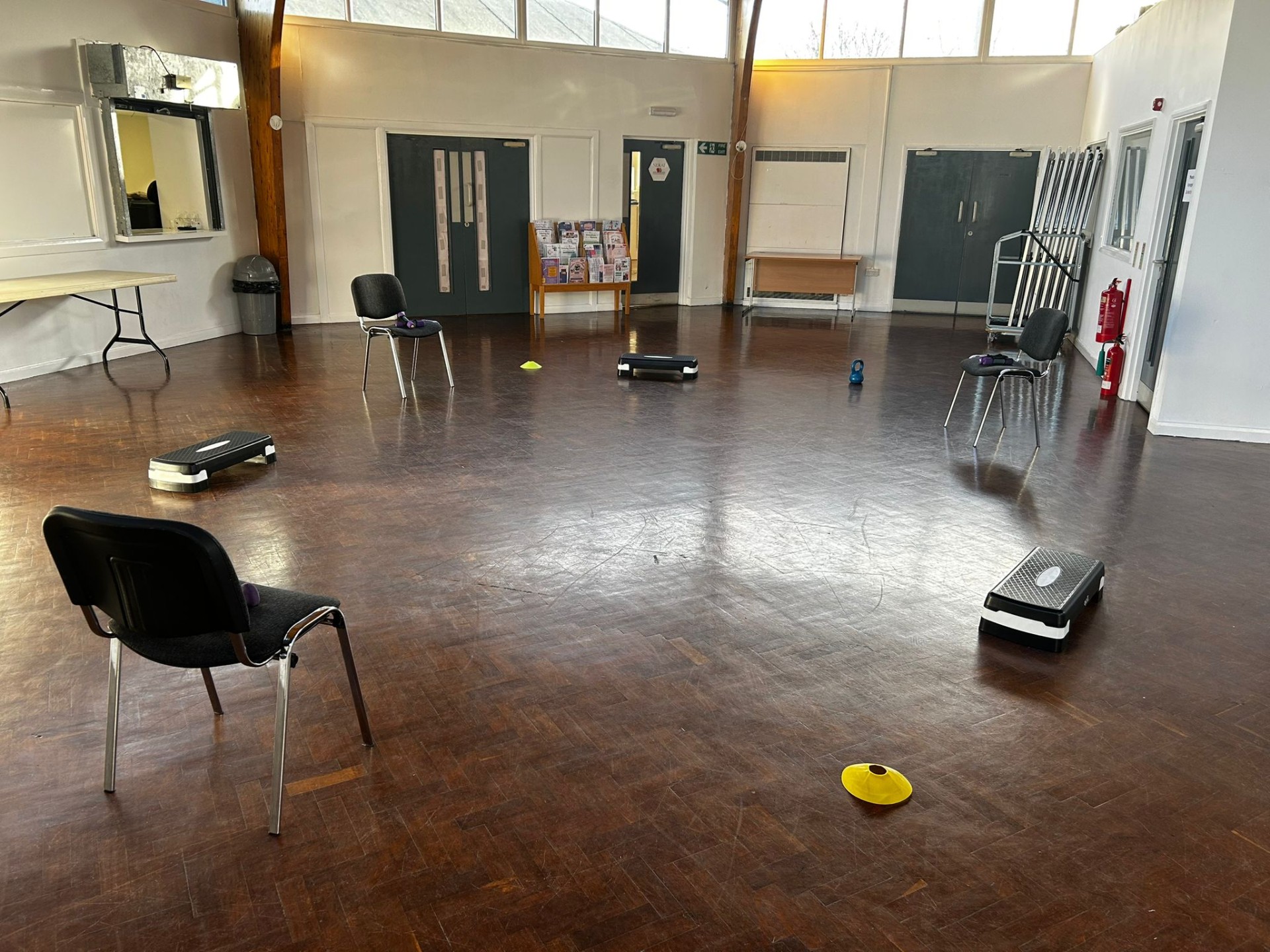 Accessible workout set up including chairs, cones, steps and dumbbells