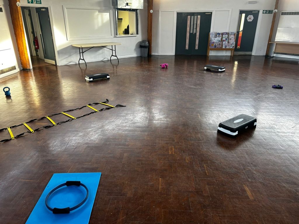 Circuit fitness set up with steppers, dumbbells, yoga mats and more